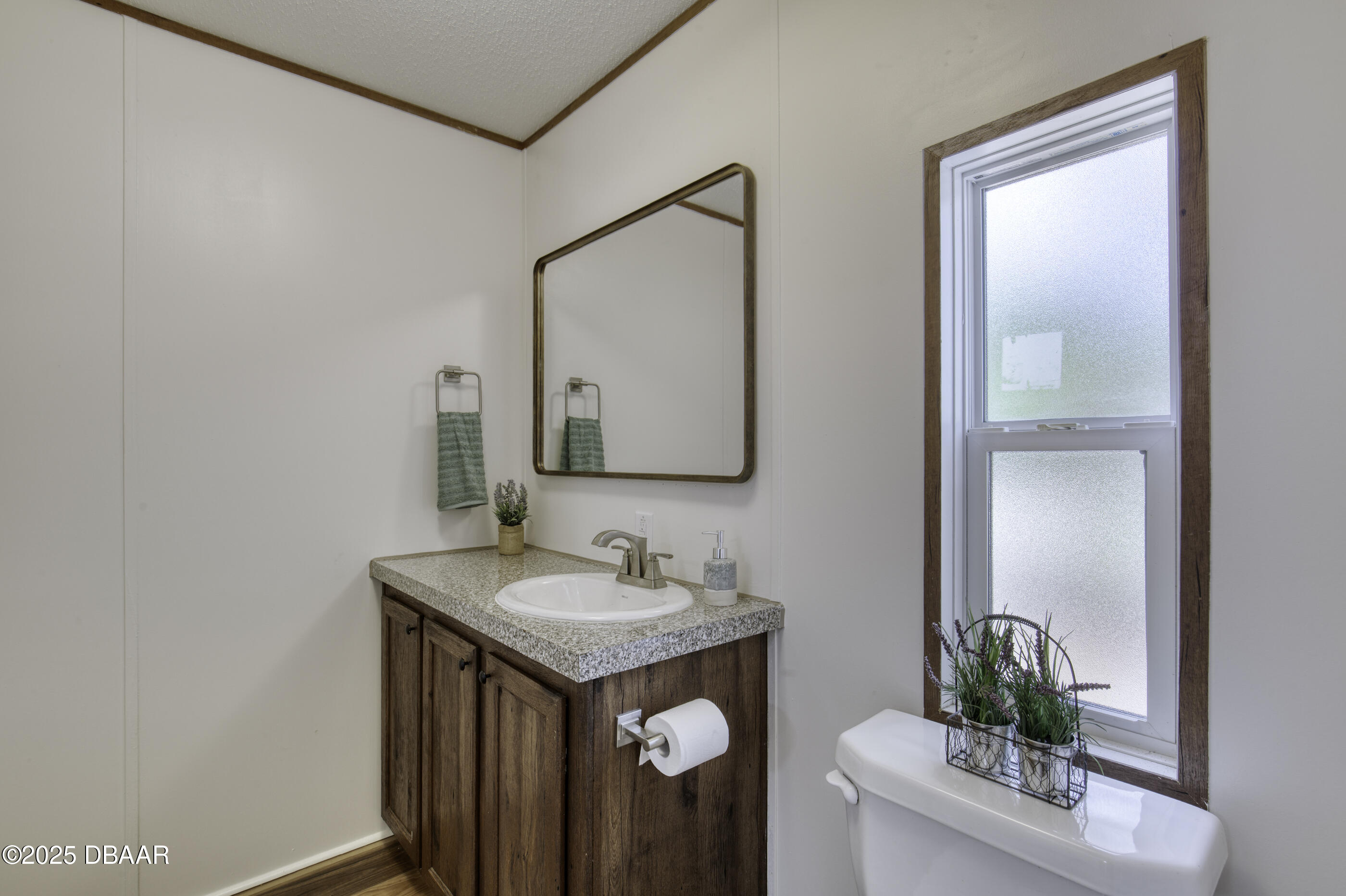 2089 Guava Lane Bunnell, FL 32110 - Photo 30 of 58 a bathroom with a sink a vanity and a mirror