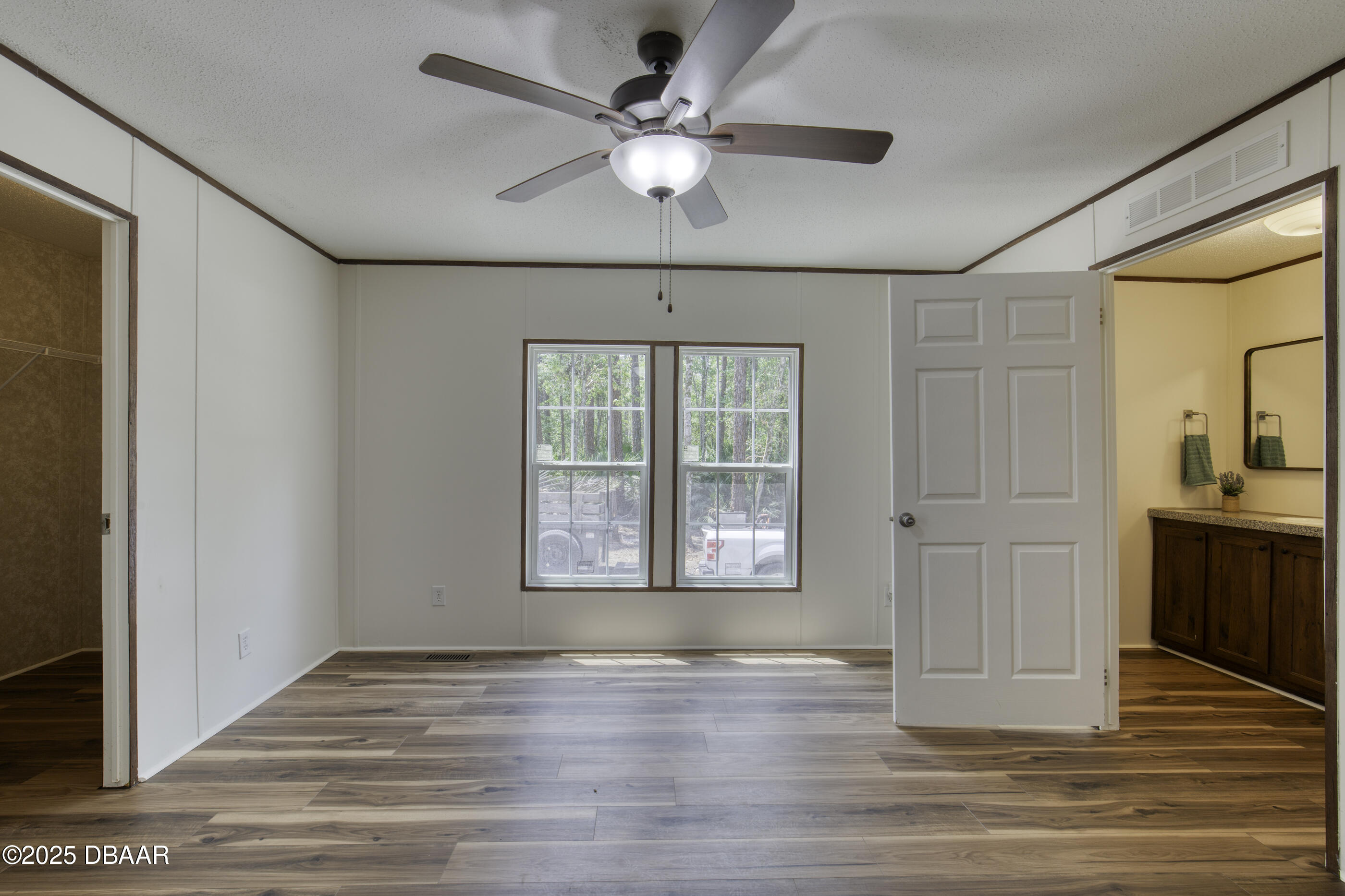 2089 Guava Lane Bunnell, FL 32110 - Photo 31 of 58 a view of an empty room with a window and wooden floor