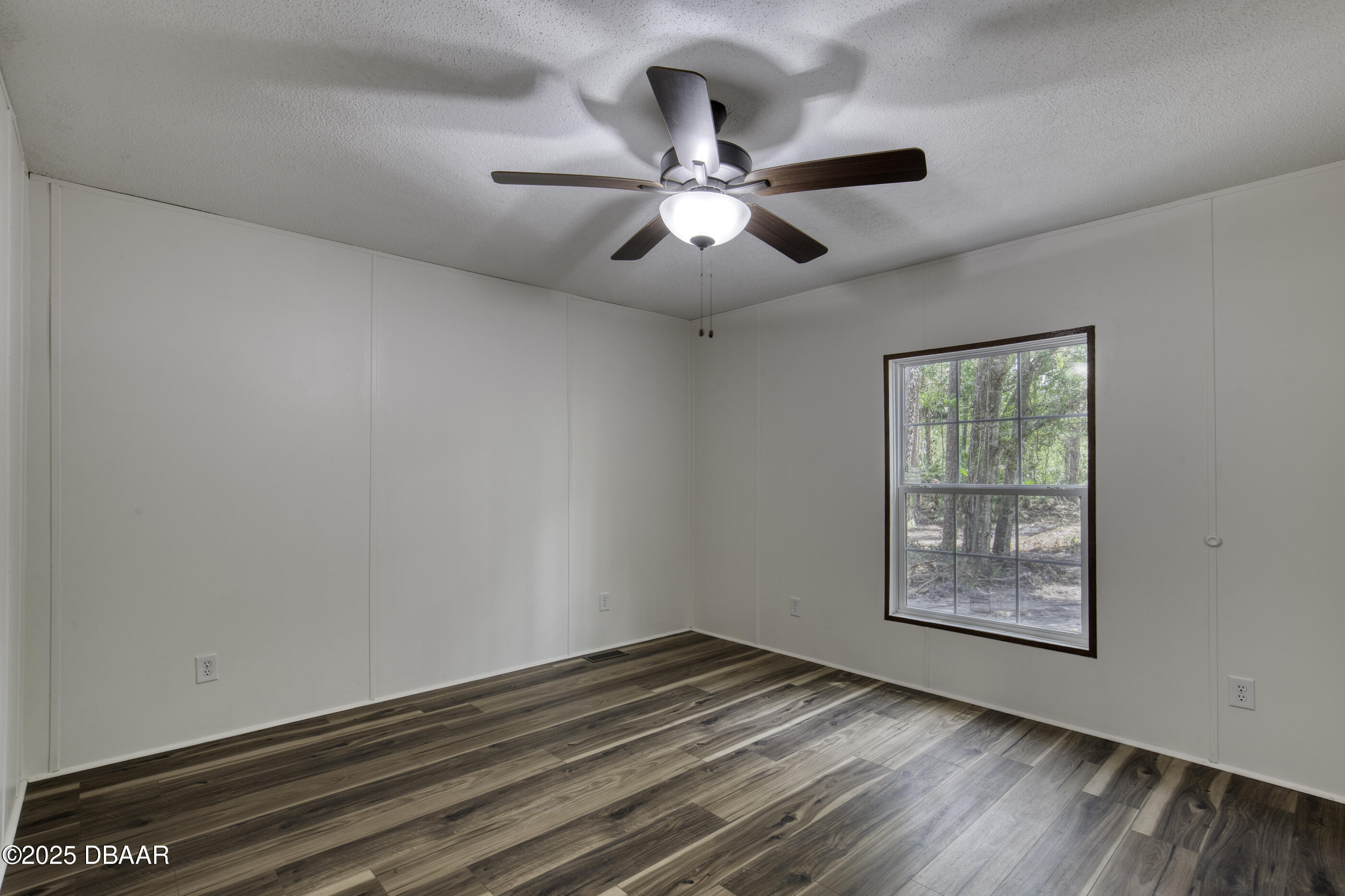 2089 Guava Lane Bunnell, FL 32110 - Photo 32 of 58 a view of an empty room with wooden floor and a window
