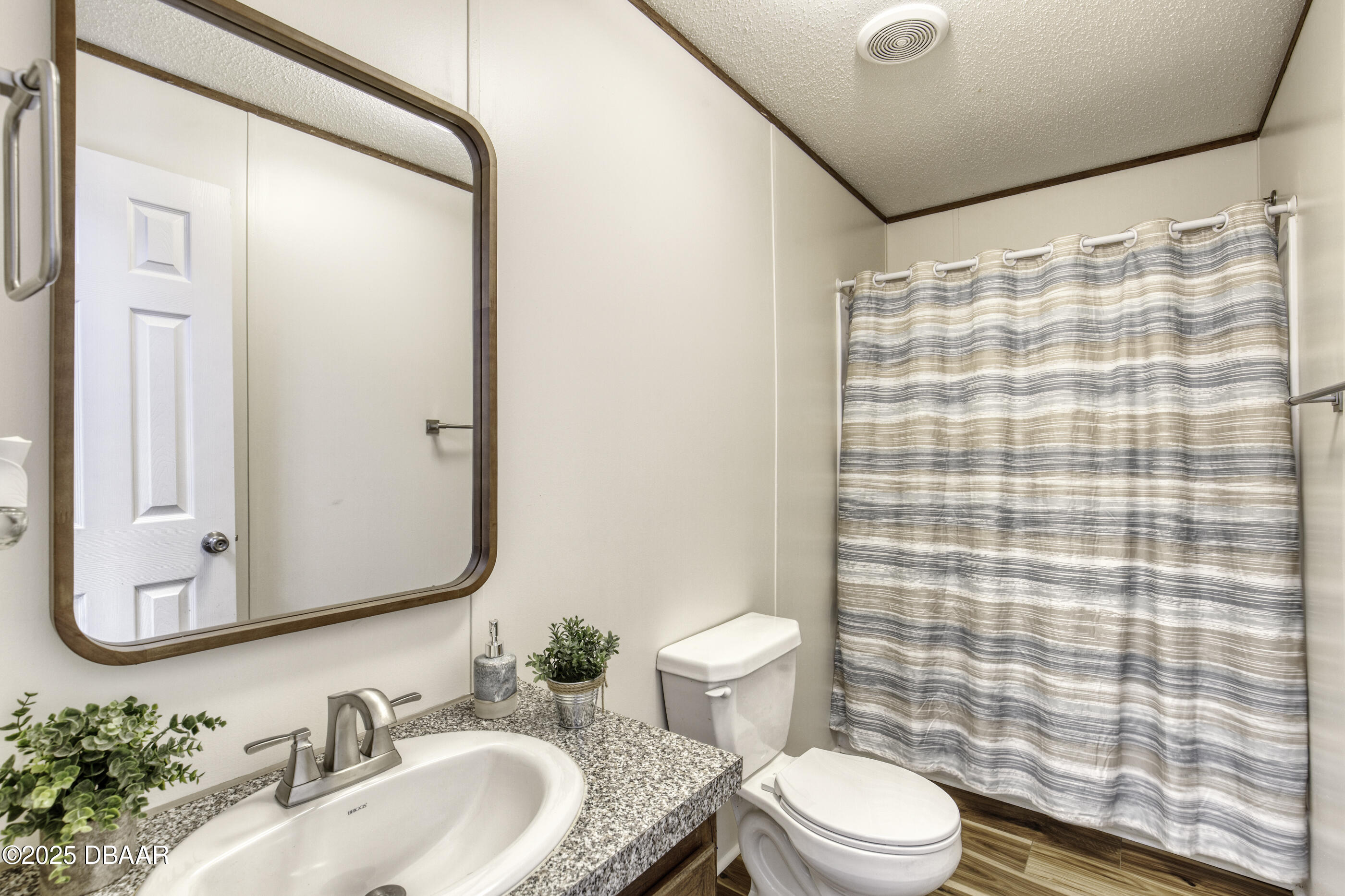 2089 Guava Lane Bunnell, FL 32110 - Photo 35 of 58 a bathroom with a sink a toilet and shower curtain