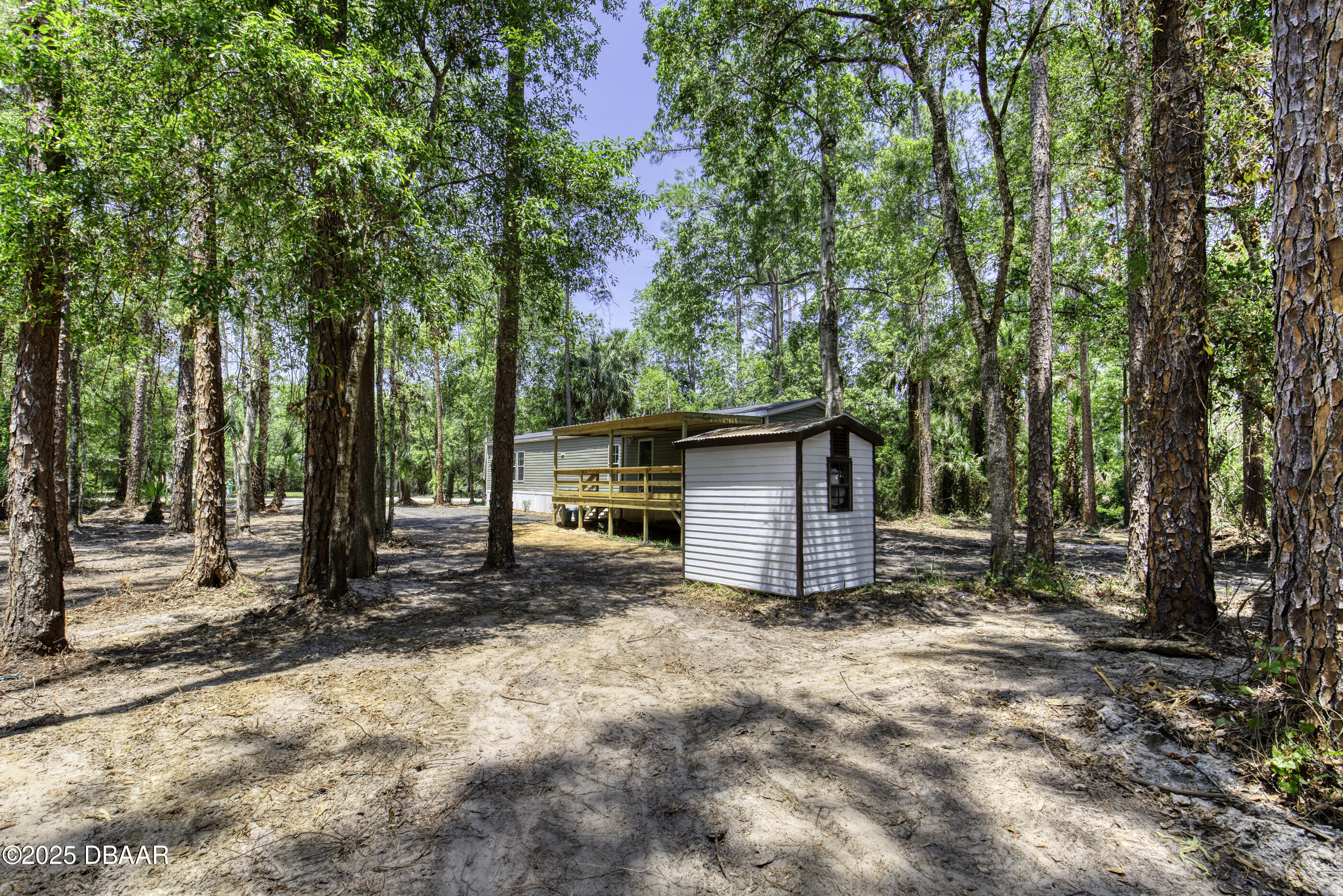 2089 Guava Lane Bunnell, FL 32110 - Photo 42 of 58 a view of a house with large trees and wooden fence