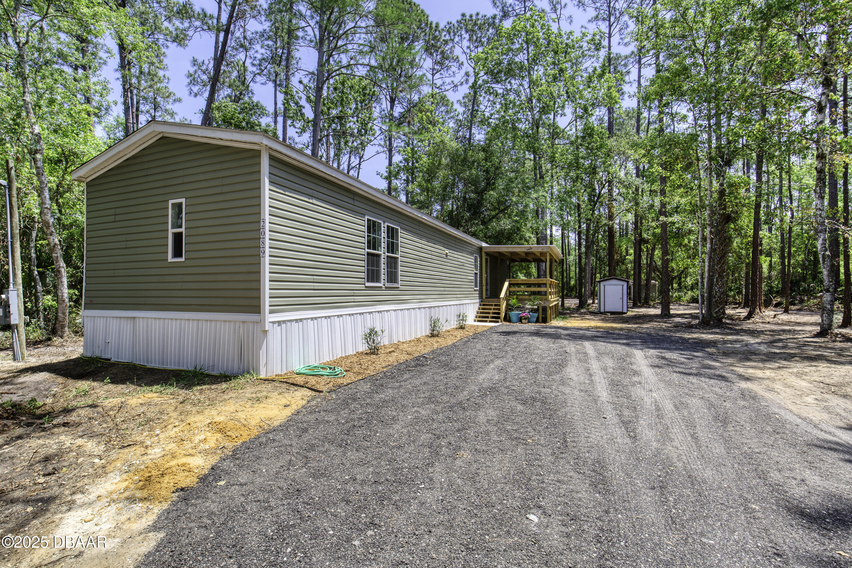 2089 Guava Lane Bunnell, FL 32110 - Photo 5 of 58 a view of a house with a yard and large tree