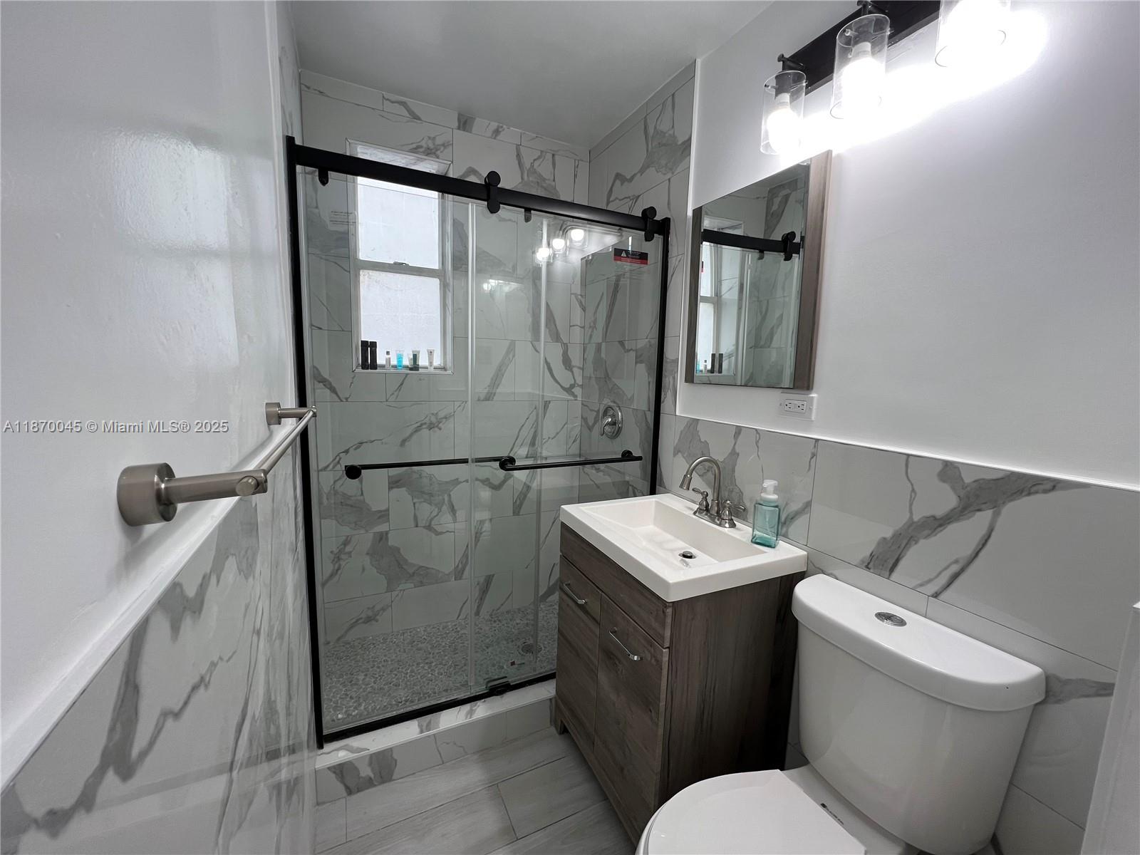 3710 Collins Avenue, Unit N103 Miami Beach, FL 33140 - Photo 29 of 53 a bathroom with a sink toilet and shower