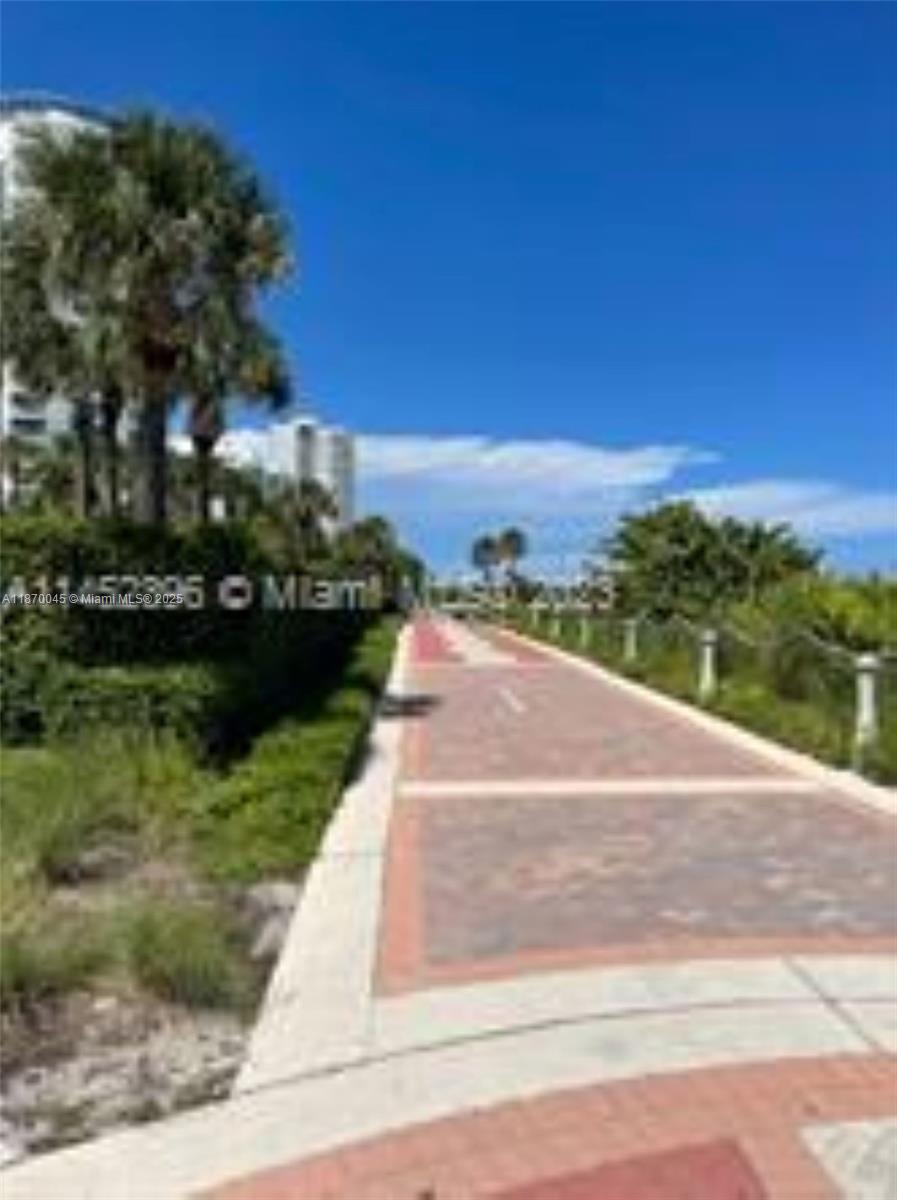 3710 Collins Avenue, Unit N103 Miami Beach, FL 33140 - Photo 49 of 53 a view of city street with a yard