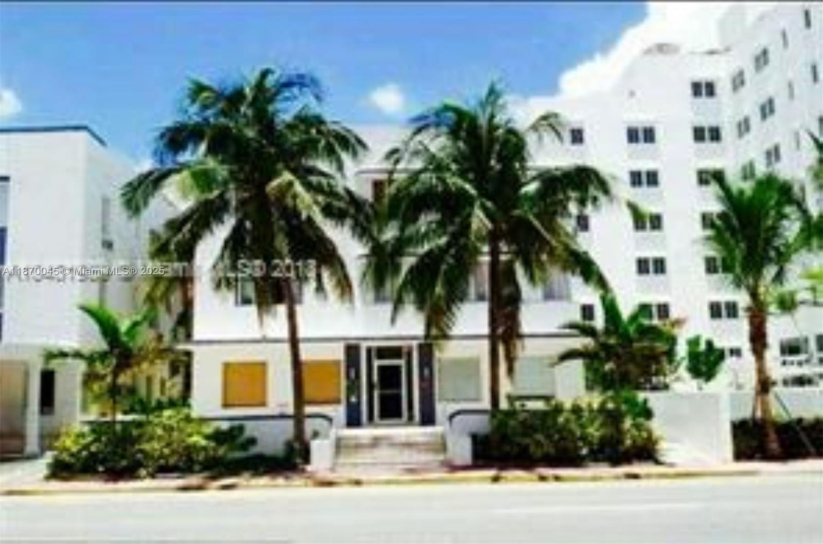 3710 Collins Avenue, Unit N103 Miami Beach, FL 33140 - Photo 52 of 53 a front view of multi story residential apartment building with yard and sign board