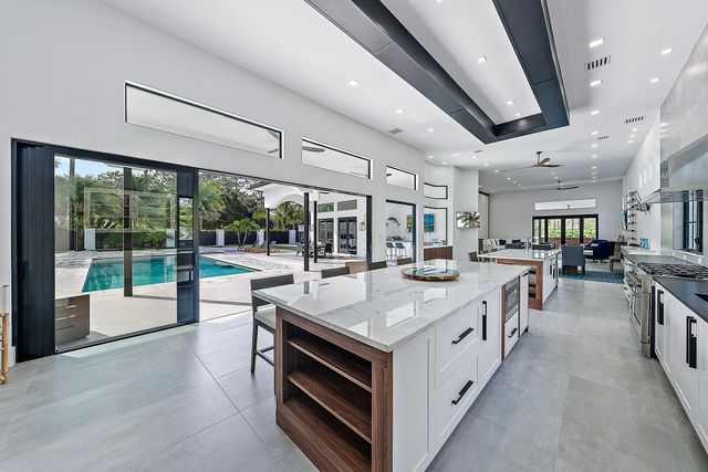 a living room with furniture and large windows