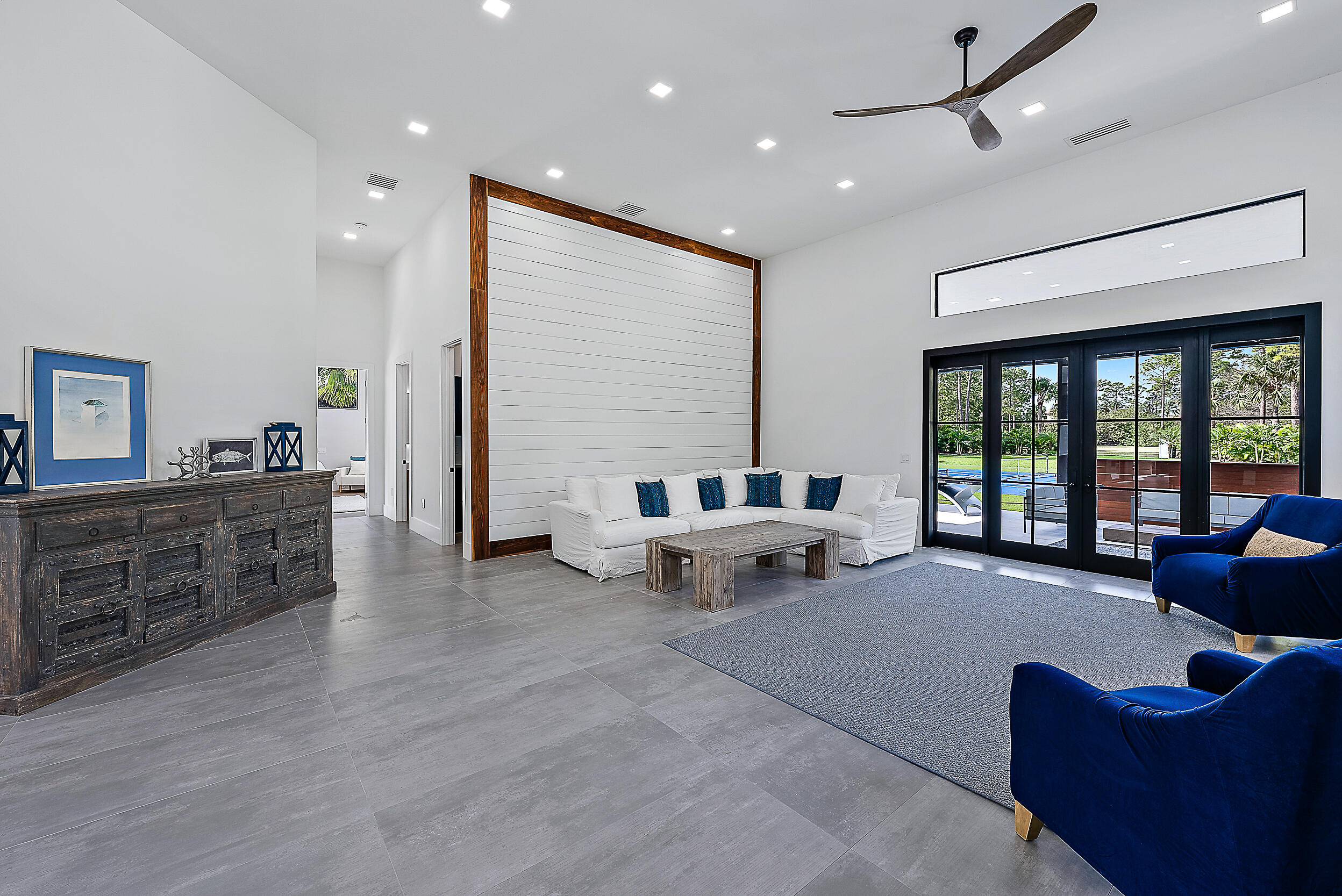 18890 Southeast Jupiter Road Jupiter, FL 33458 - Photo 16 of 33 a living room with furniture and large windows