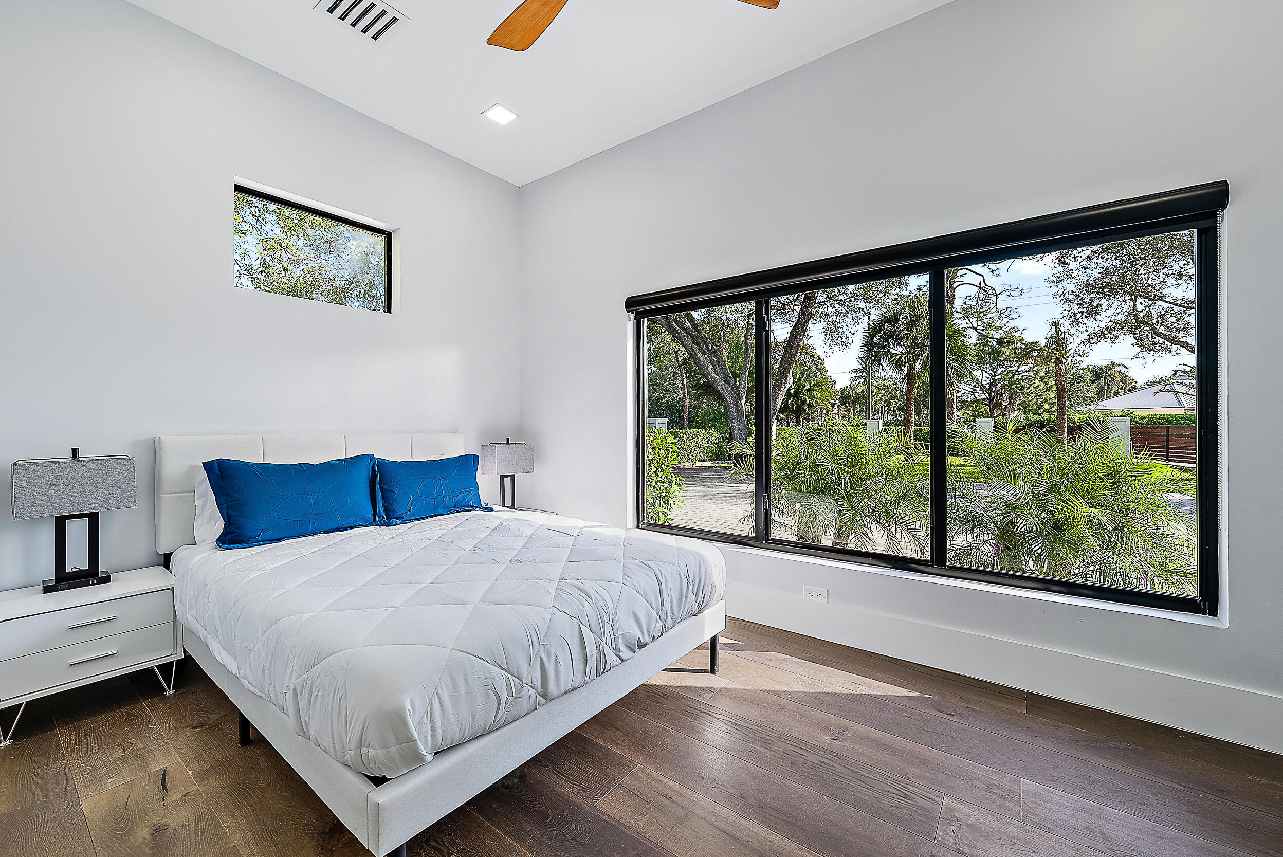 18890 Southeast Jupiter Road Jupiter, FL 33458 - Photo 17 of 33 a bedroom with a large bed and a large window