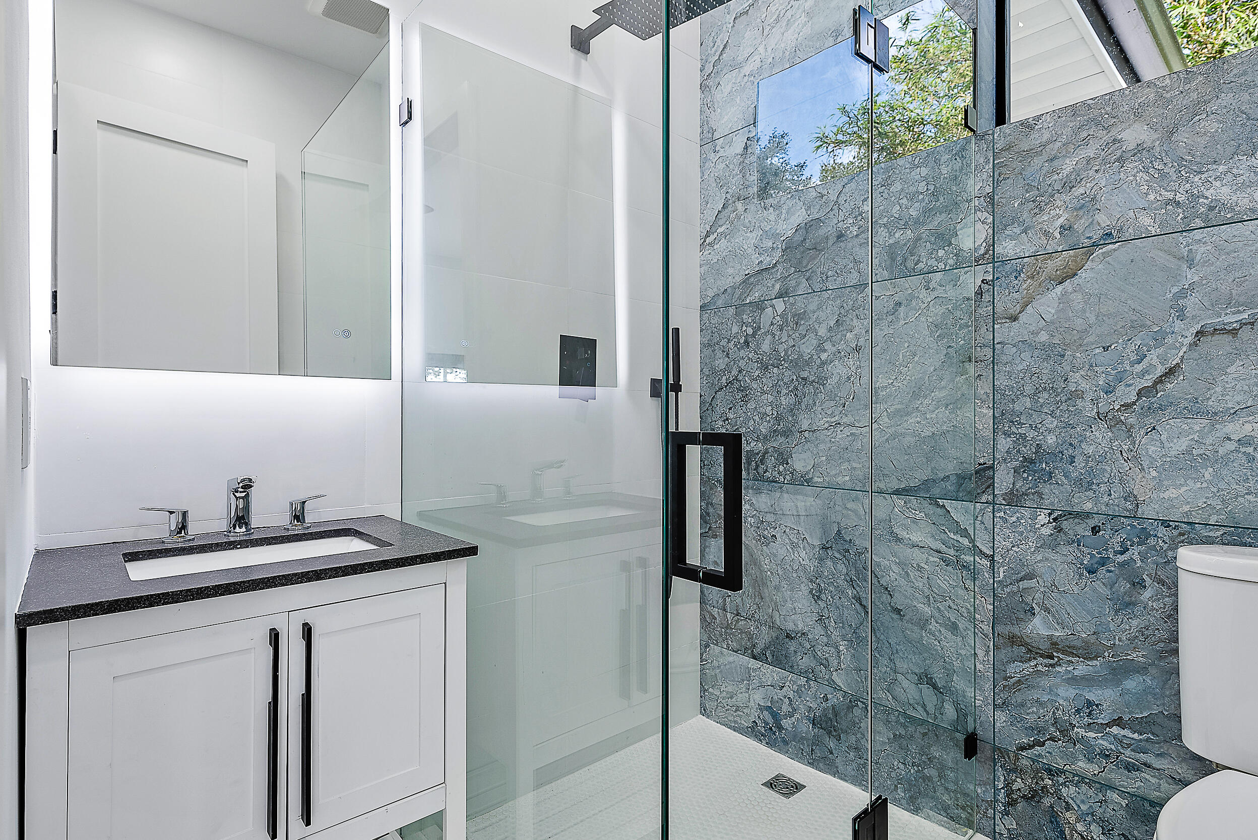 18890 Southeast Jupiter Road Jupiter, FL 33458 - Photo 18 of 33 a bathroom with a granite countertop sink a mirror and shower