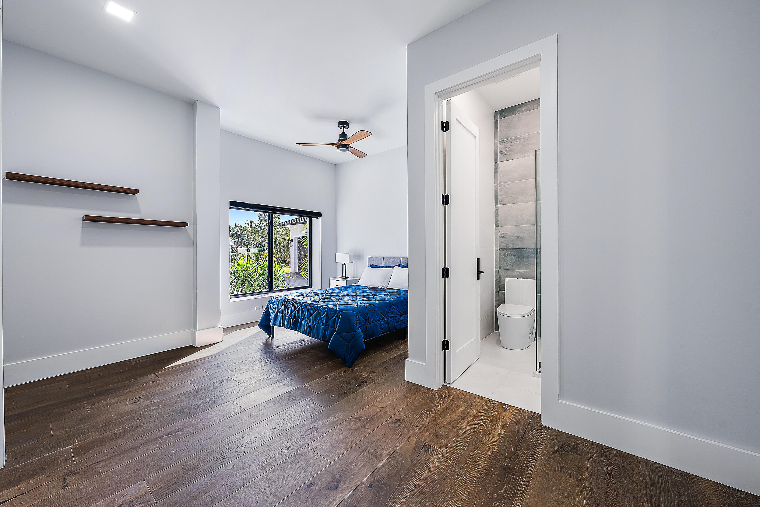 18890 Southeast Jupiter Road Jupiter, FL 33458 - Photo 22 of 33 a spacious bedroom with a bed and a window