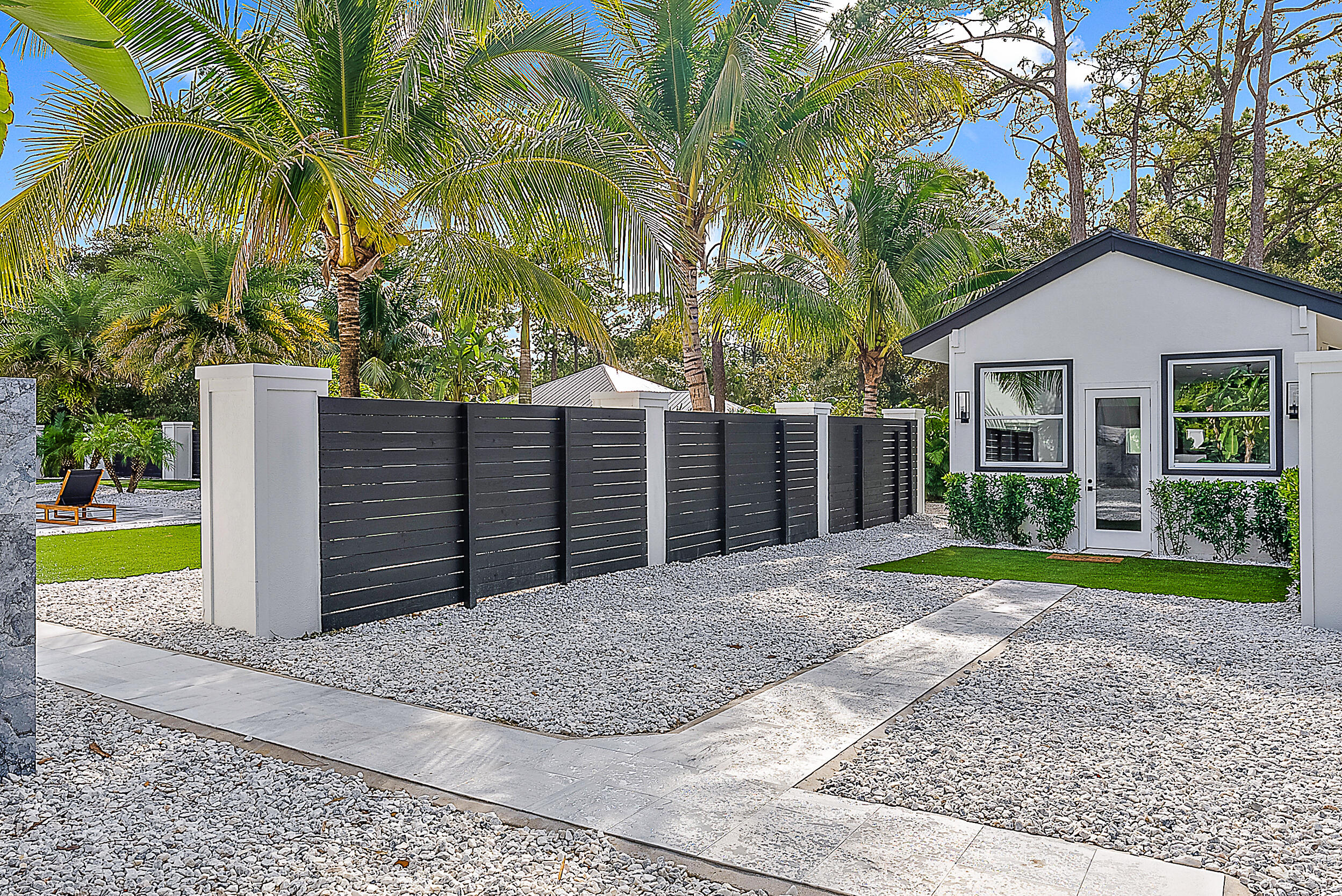 18890 Southeast Jupiter Road Jupiter, FL 33458 - Photo 24 of 33 a view of a house with a yard and palm trees