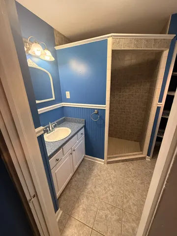 a bathroom with a mirror and a shower