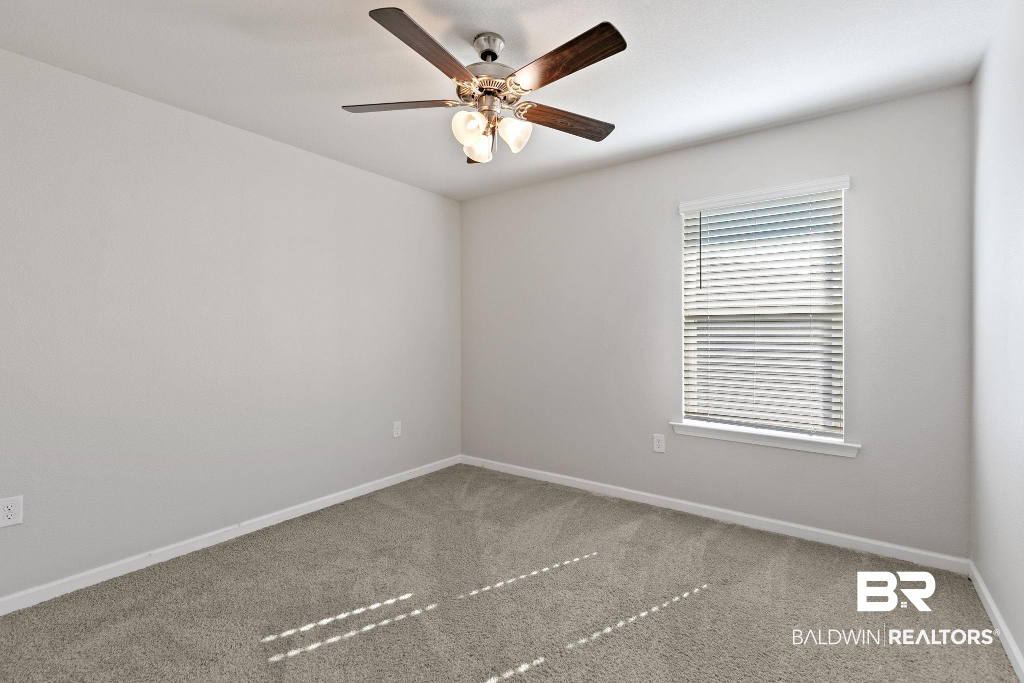 32234 Calder Court Daphne, AL 36527 - Photo 27 of 32 Carpeted empty room with baseboards and a ceiling fan