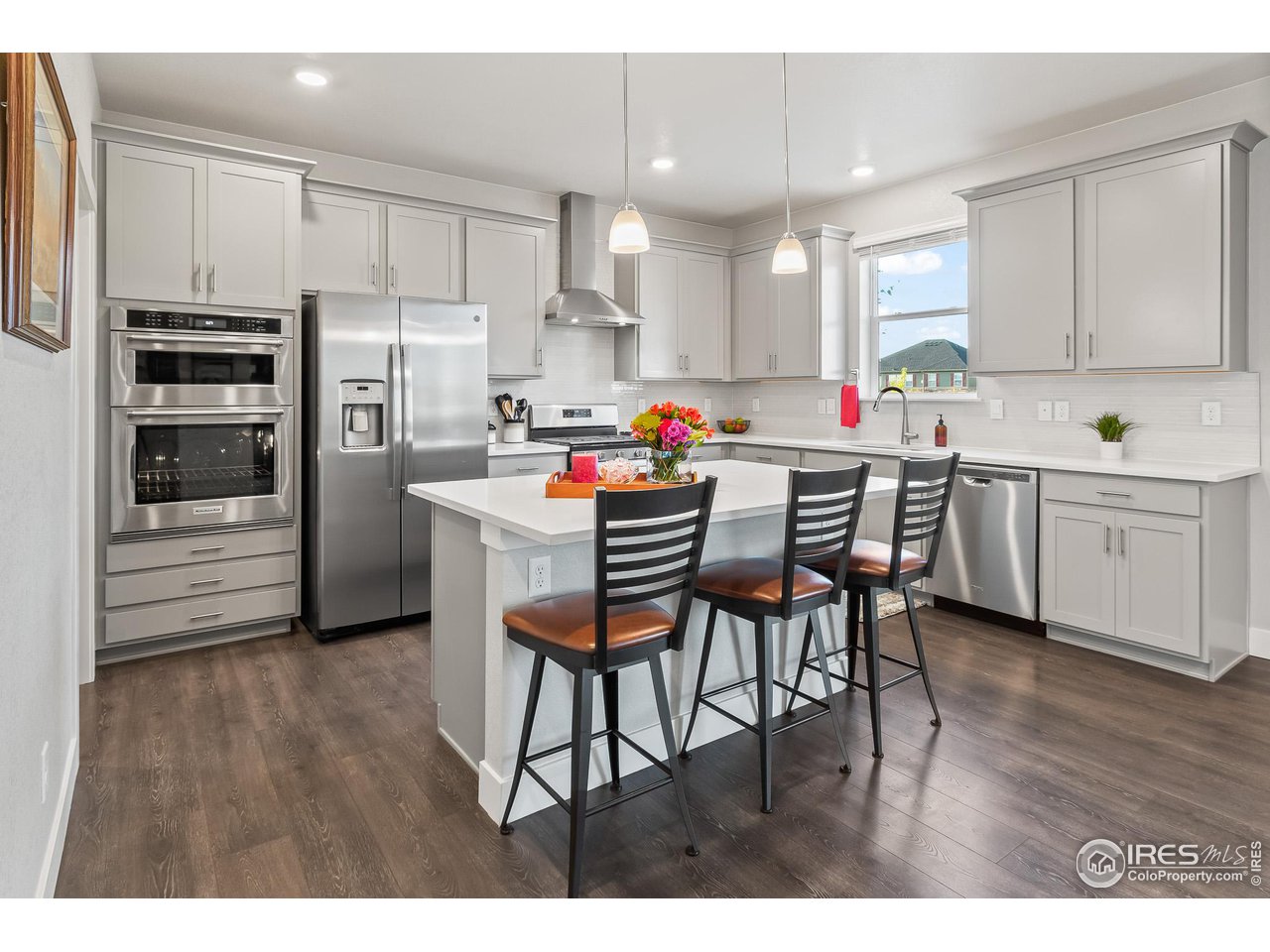 1687 Rivergate Way Berthoud, CO 80513 - Photo 22 of 39 a kitchen with kitchen island wooden cabinets and stainless steel appliances