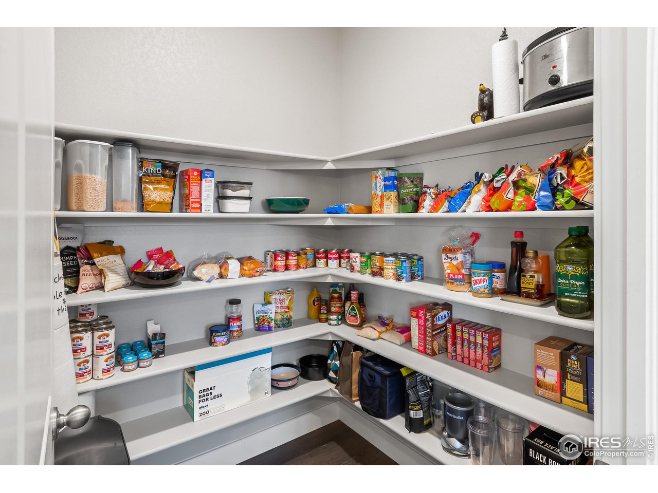1687 Rivergate Way Berthoud, CO 80513 - Photo 25 of 39 a kitchen with lots of clutter and cabinets