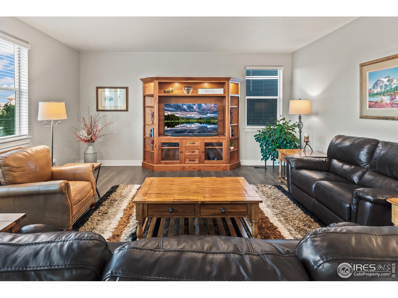 1687 Rivergate Way Berthoud, CO 80513 - Photo 28 of 39 a living room with furniture and a flat screen tv