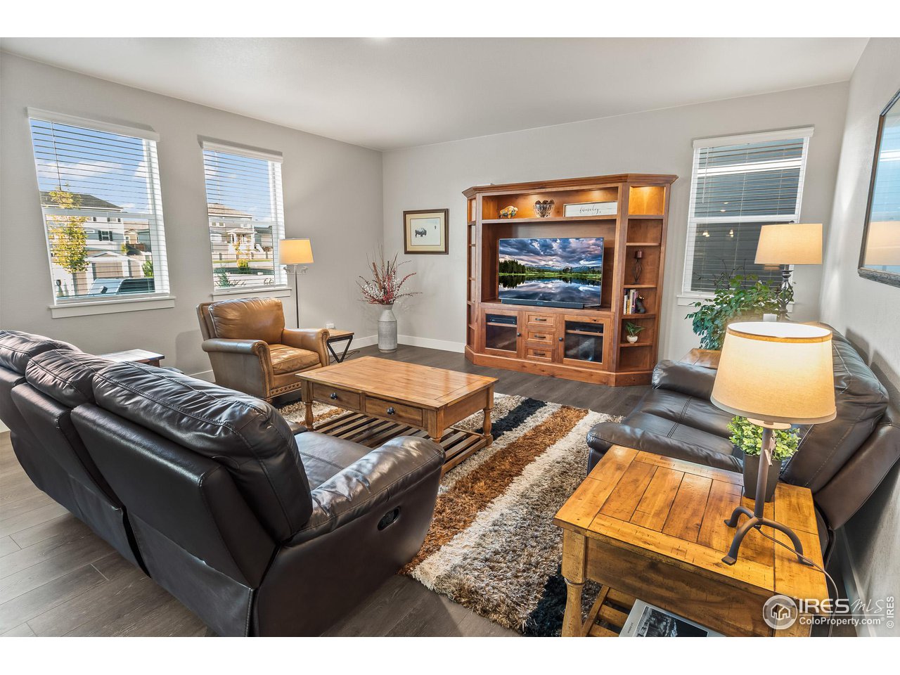 1687 Rivergate Way Berthoud, CO 80513 - Photo 30 of 39 a living room with furniture and a flat screen tv