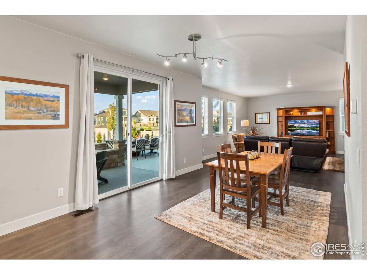 1687 Rivergate Way Berthoud, CO 80513 - Photo 31 of 39 a dining room with wooden floor and a chandelier