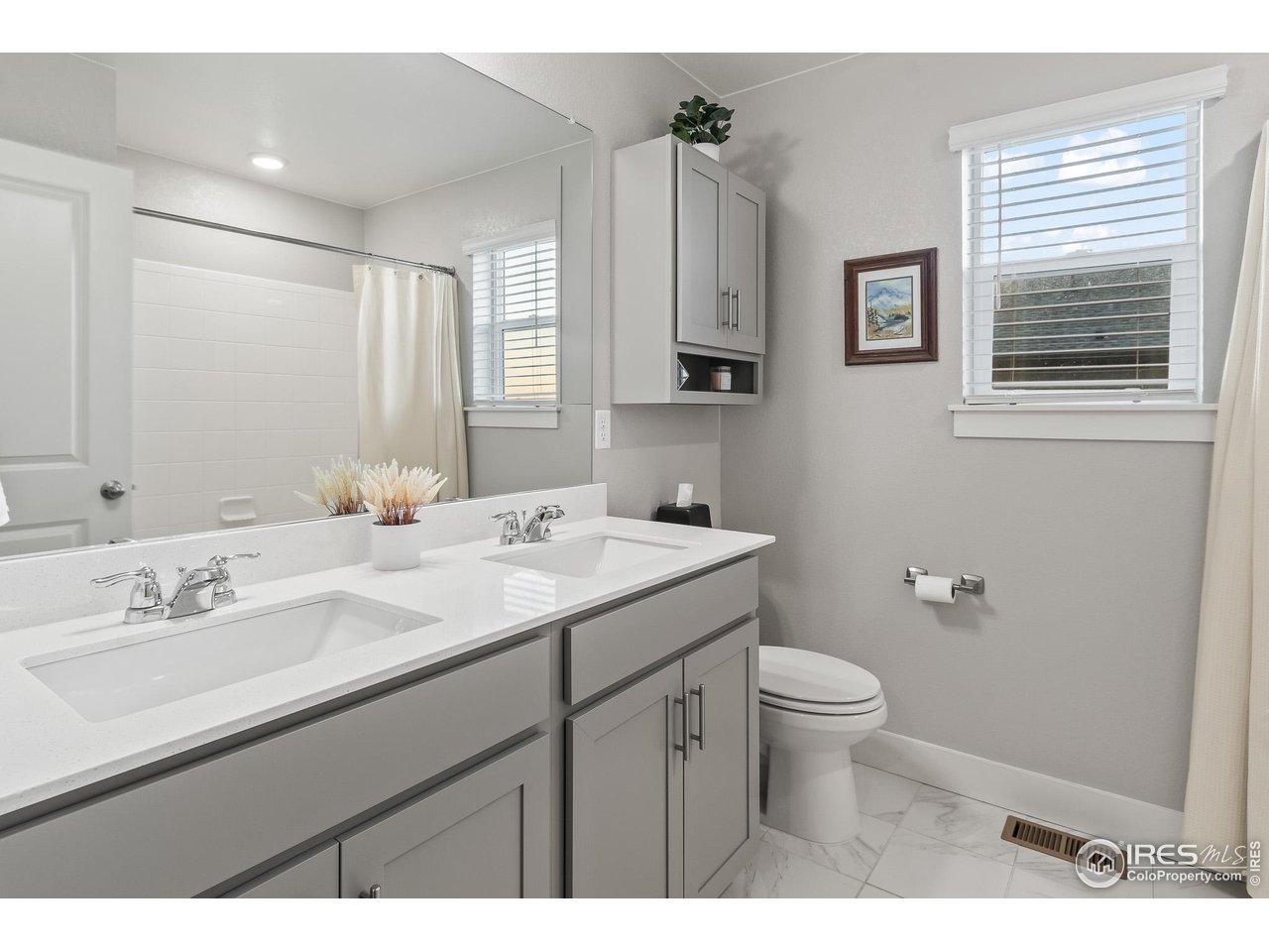 1687 Rivergate Way Berthoud, CO 80513 - Photo 32 of 39 a bathroom with a sink toilet and mirror