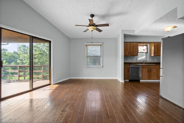 a view of a kitchen with wooden floor and a kitchen
