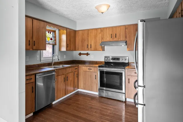 a kitchen with a sink stove and cabinets