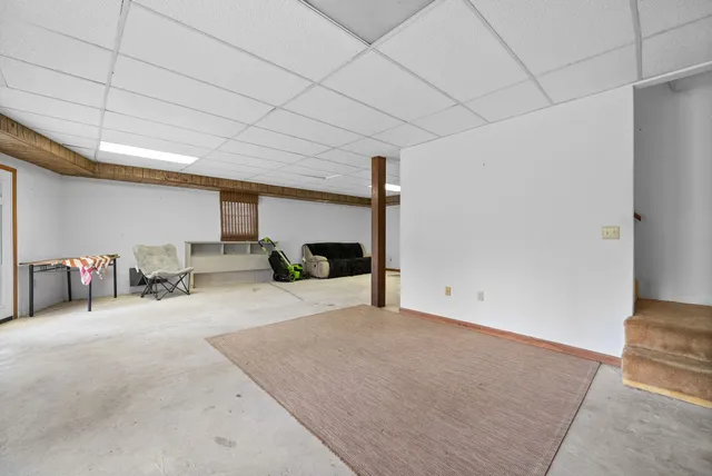 a view of a livingroom with furniture and white walls