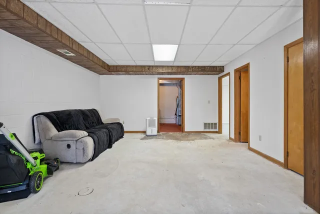 a view of a livingroom with furniture and staircase