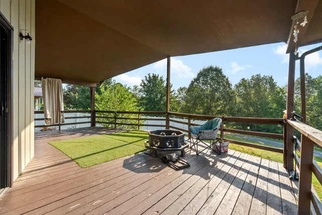 a view of a balcony with chairs and wooden floor