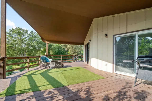 a view of a patio with a table chairs and a backyard