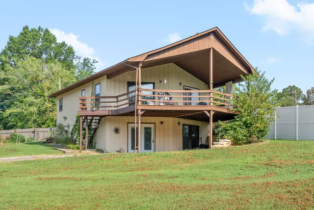 a view of a house with a yard and potted plants