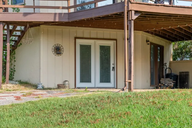 a view of a house with backyard door and wooden fence