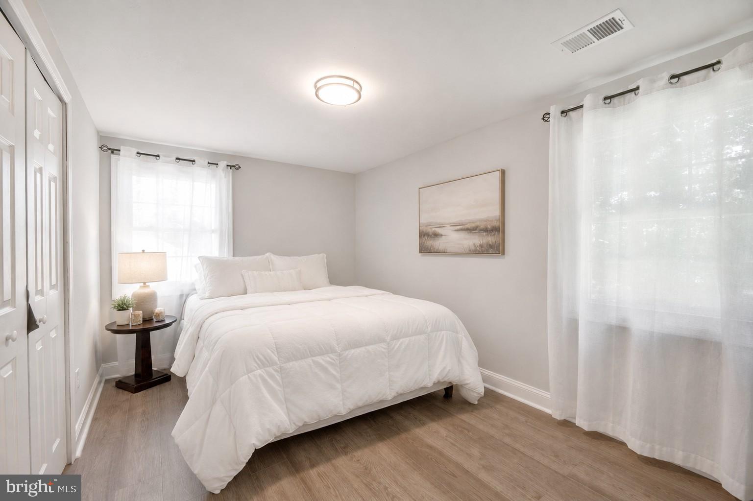 8812 Churchfield Lane Laurel, MD 20708 - Photo 21 of 31 a bedroom with a bed and a painting on the wall