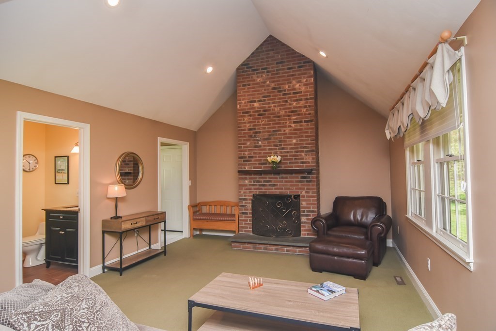 151 School Street Acton, MA 01720 - Photo 11 of 39 a living room with furniture and a fireplace