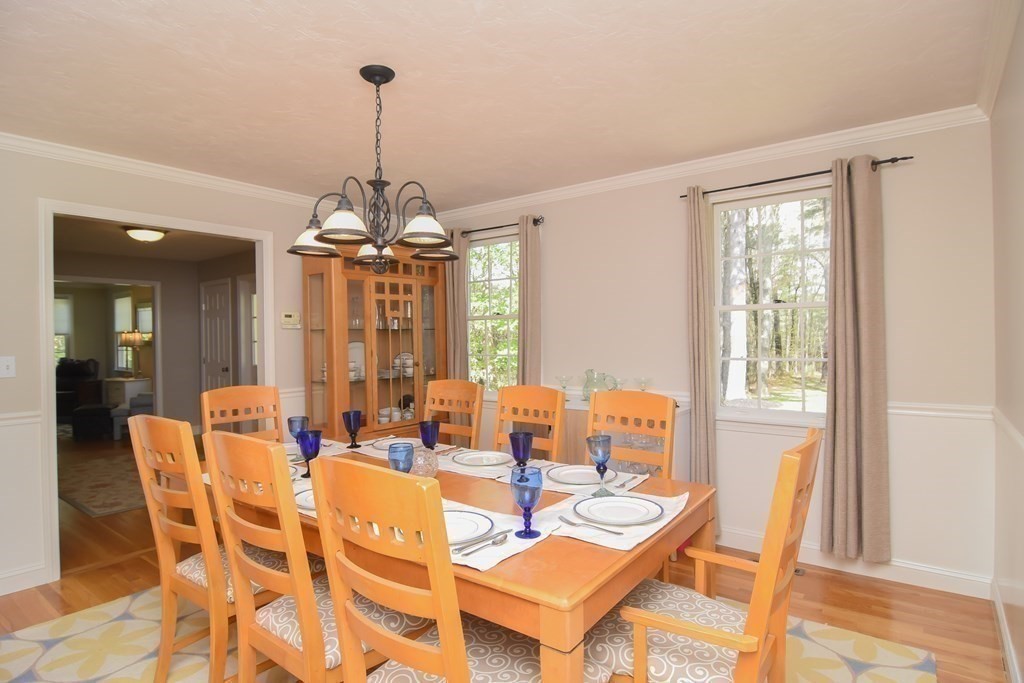 151 School Street Acton, MA 01720 - Photo 12 of 39 a dining room with furniture a chandelier and wooden floor