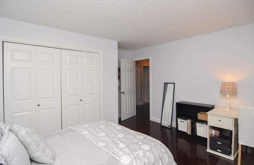 151 School Street Acton, MA 01720 - Photo 17 of 39 a bedroom with a bed and a mirror