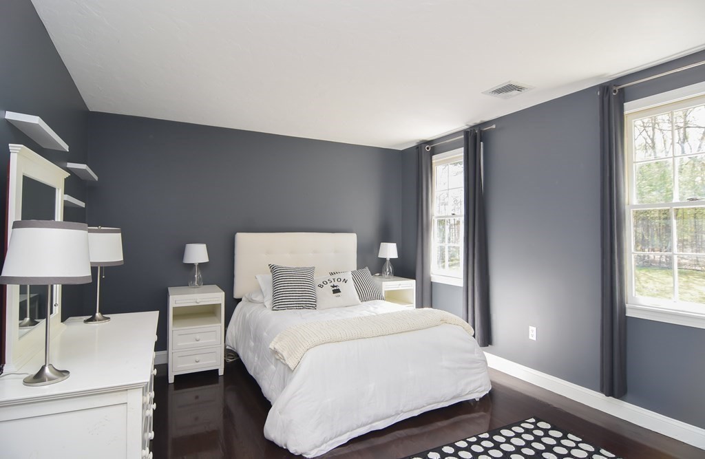 151 School Street Acton, MA 01720 - Photo 19 of 39 a bedroom with a bed and a lamp