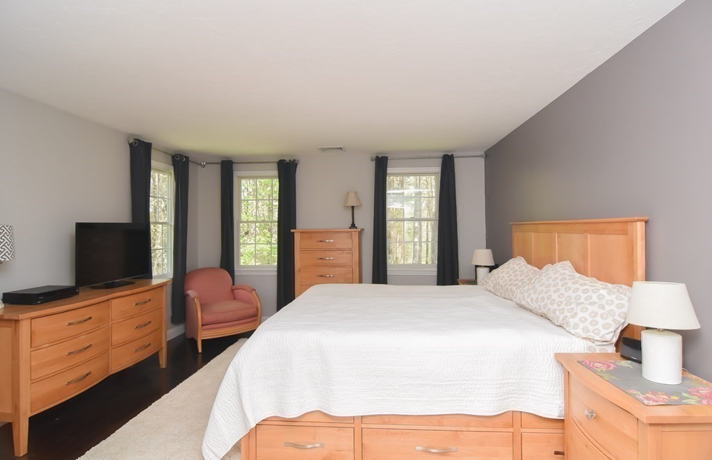 151 School Street Acton, MA 01720 - Photo 21 of 39 a bedroom with a bed and a flat screen tv