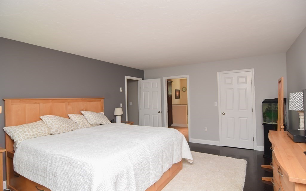 151 School Street Acton, MA 01720 - Photo 22 of 39 a bedroom with a bed and a flat screen tv