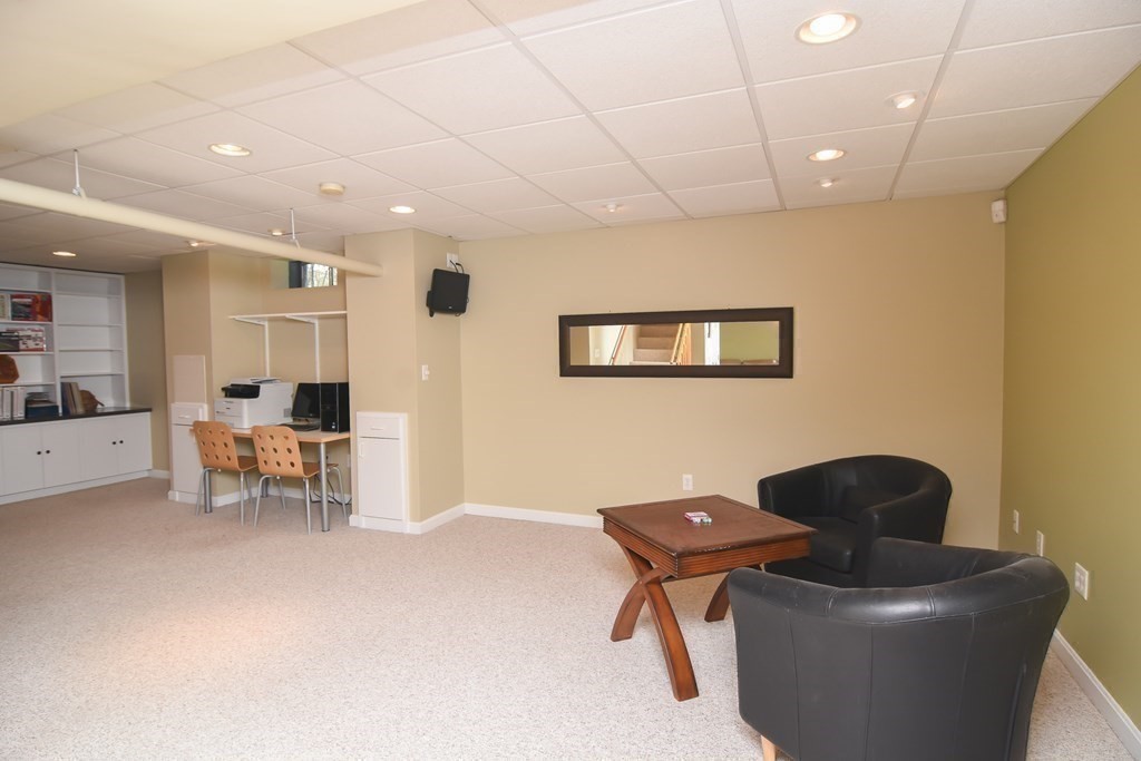 151 School Street Acton, MA 01720 - Photo 27 of 39 a living room with furniture and a chair