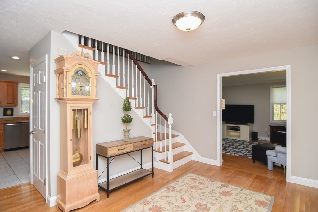 151 School Street Acton, MA 01720 - Photo 6 of 39 a view of a hallway with entryway wooden floor and windows