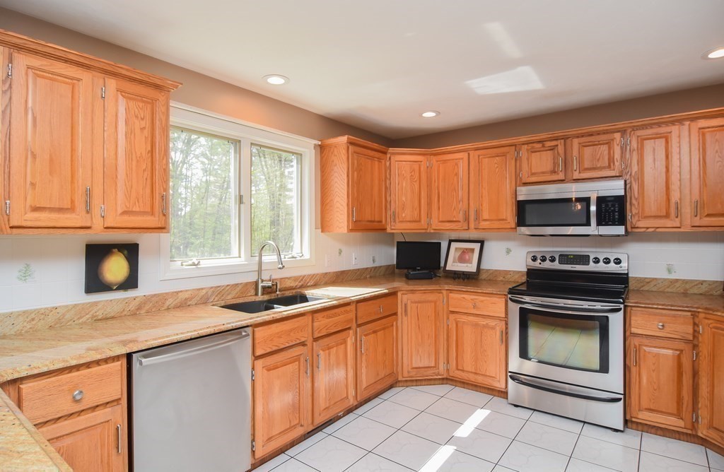 151 School Street Acton, MA 01720 - Photo 9 of 39 a kitchen with a sink stove top oven and microwave