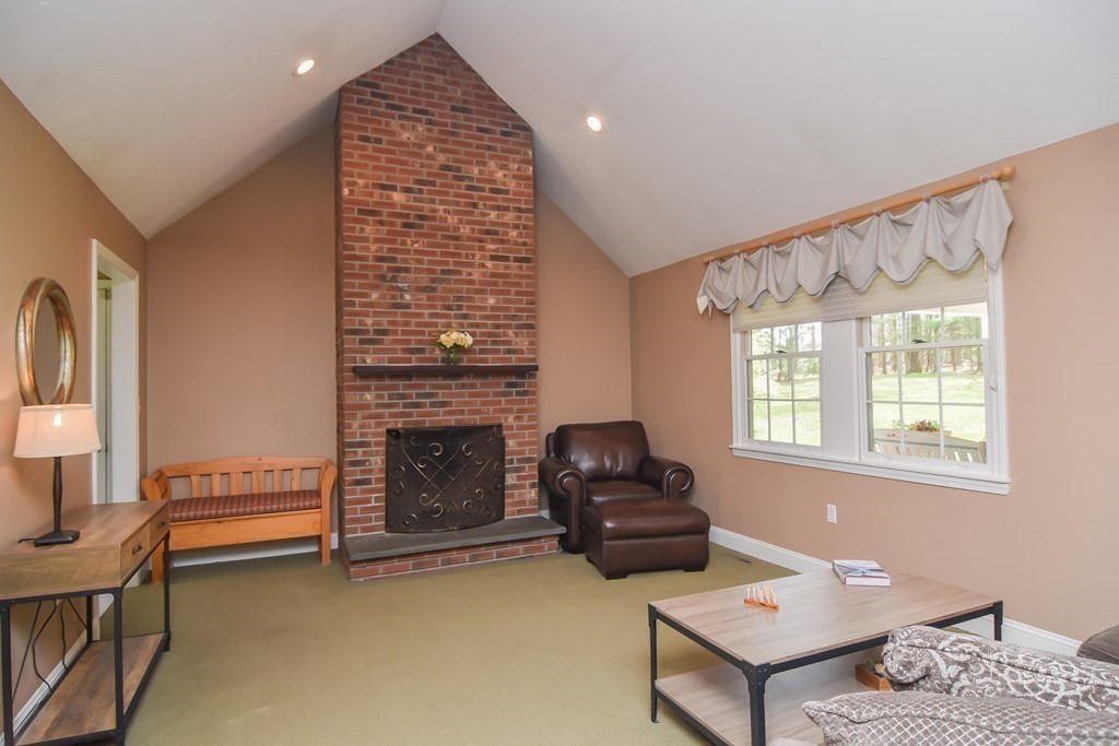 151 School Street Acton, MA 01720 - Photo 10 of 39 a living room with furniture and a fireplace
