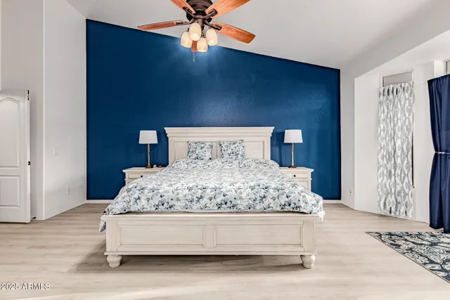 a bedroom with a bed and a chandelier