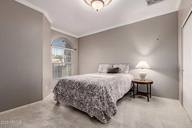 a bedroom with a bed and a lamp with window