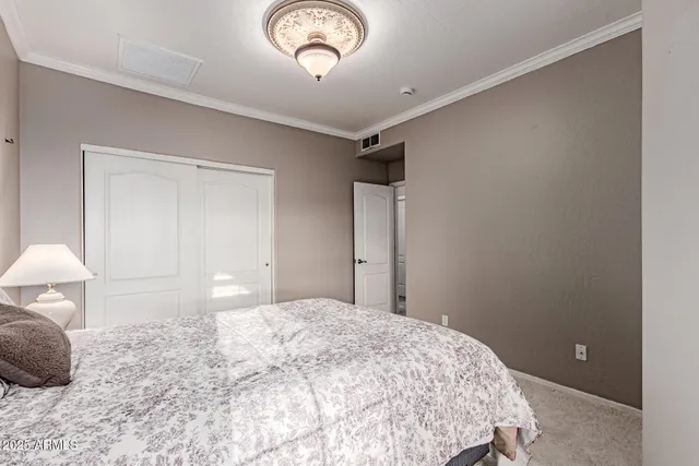 a bedroom with a bed and a chandelier