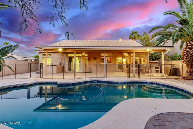 a swimming pool with outdoor seating and yard