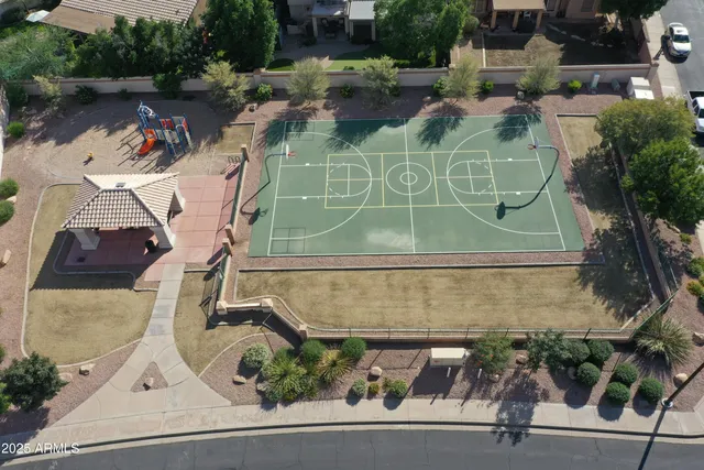 an aerial view of a house with a yard and a fountain