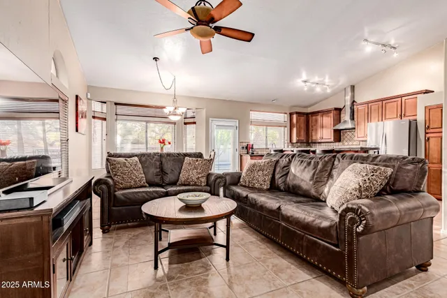 a living room with furniture and a chandelier