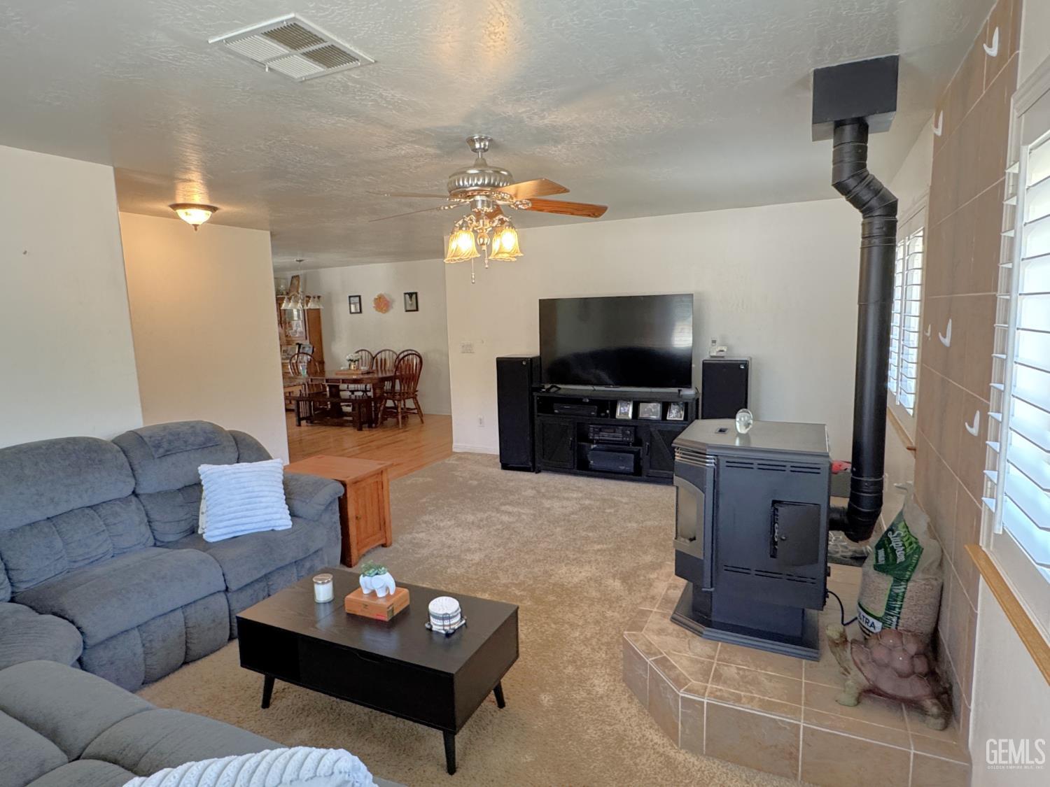 Undisclosed Address Tehachapi, CA 93561 - Photo 2 of 16 a living room with furniture a fireplace and a flat screen tv