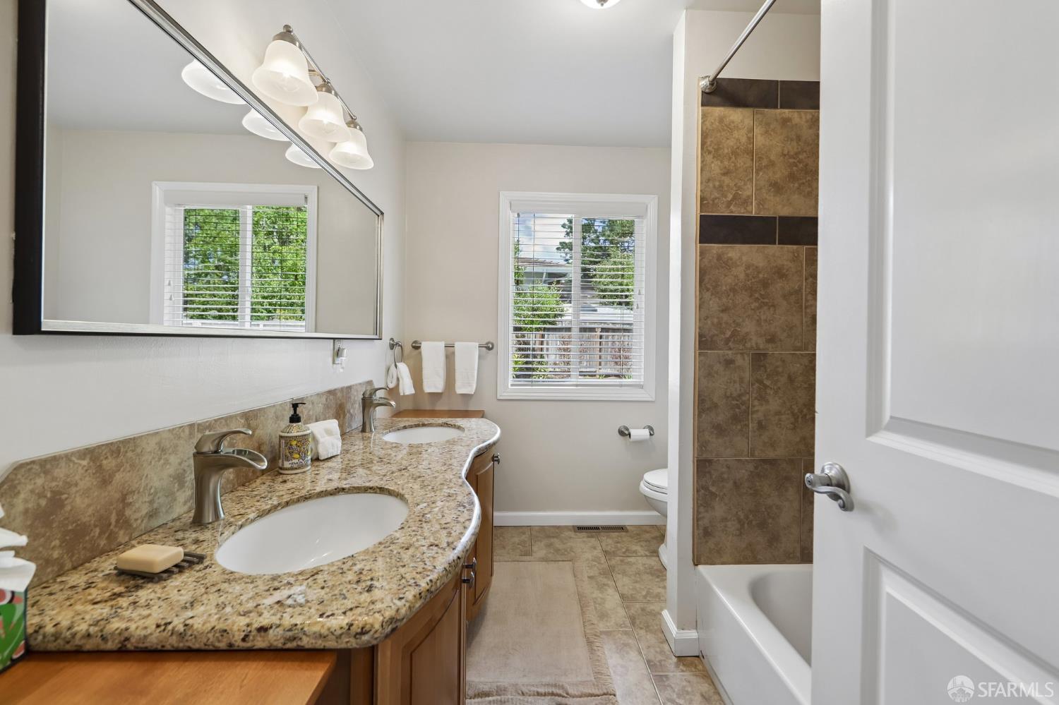 4052 Costado Road Pebble Beach, CA 93953 - Photo 23 of 35 a bathroom with a granite countertop sink and a mirror
